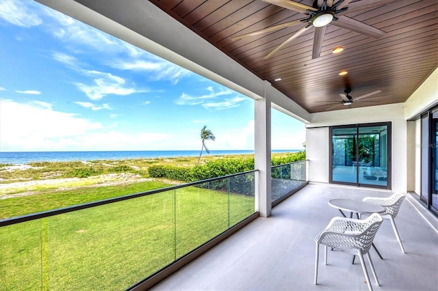 unfurnished sunroom featuring a water view, ceiling fan, and wood ceiling