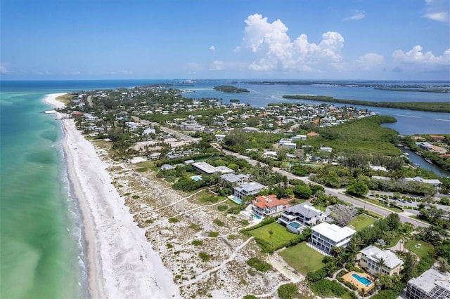 birds eye view of property with a water view and a view of the beach