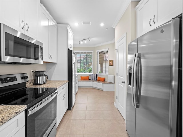 kitchen featuring light stone counters, crown molding, stainless steel appliances, and white cabinets