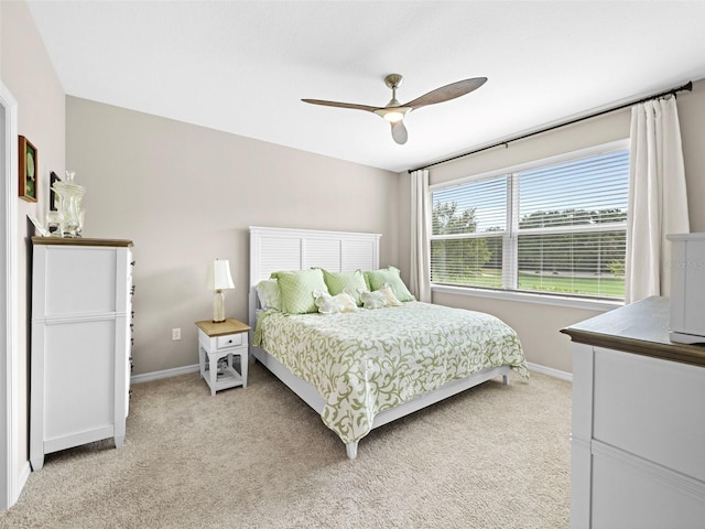 bedroom with ceiling fan and light carpet