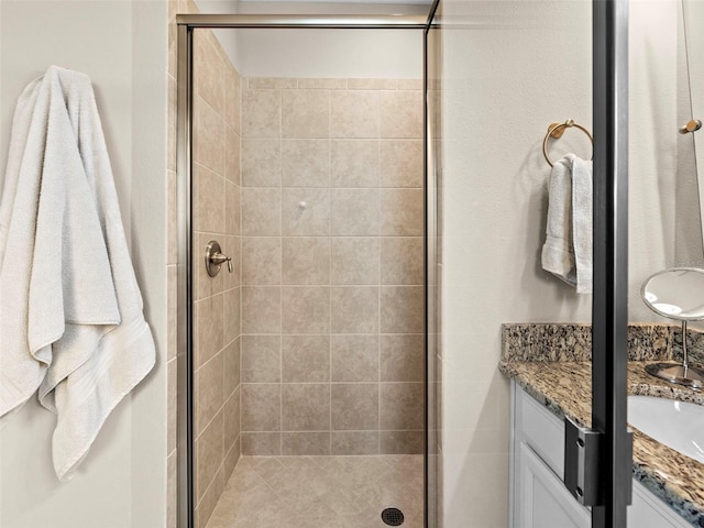 bathroom featuring vanity and a shower with shower door