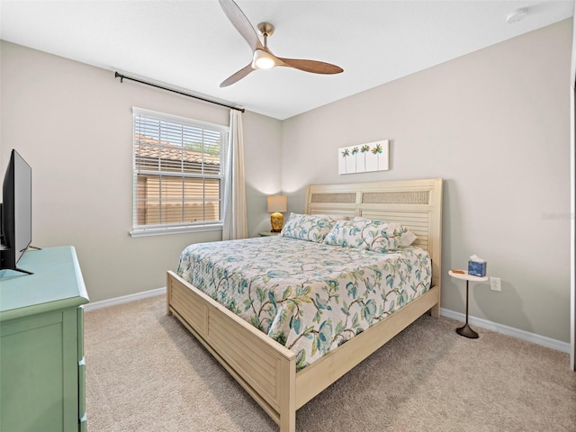 bedroom with light carpet and ceiling fan