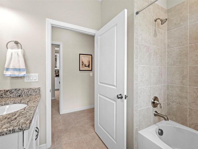 bathroom with vanity, tiled shower / bath combo, and tile patterned floors