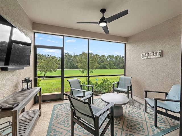 sunroom / solarium with ceiling fan and a healthy amount of sunlight