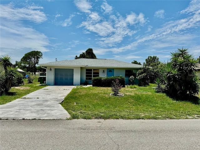 single story home featuring a garage and a front lawn