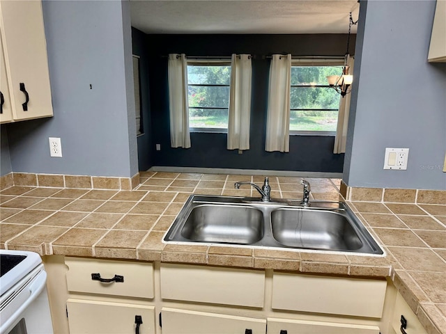 kitchen featuring sink, tile countertops, and plenty of natural light