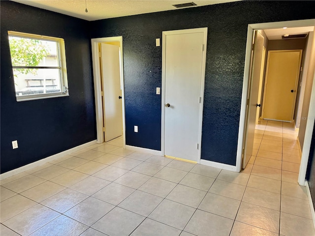 unfurnished bedroom featuring light tile patterned floors