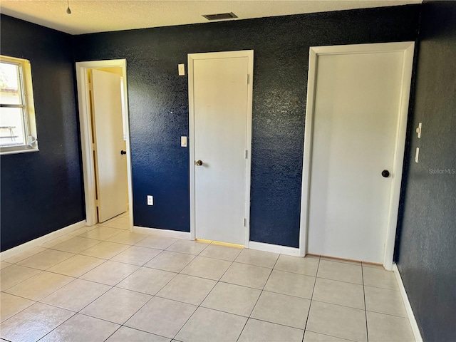 unfurnished bedroom with light tile patterned floors