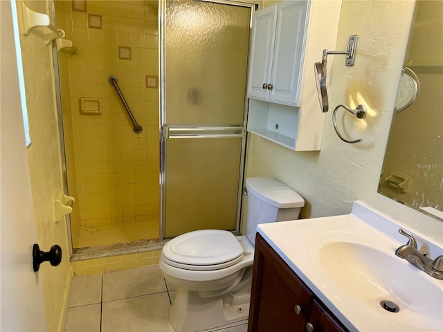 bathroom featuring vanity, an enclosed shower, toilet, and tile patterned floors