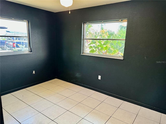 spare room featuring light tile patterned floors