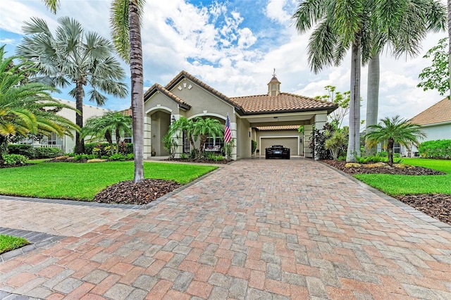 mediterranean / spanish-style home featuring a garage and a front lawn