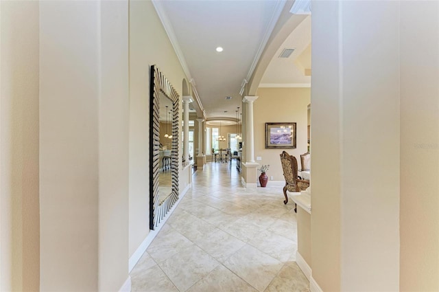 hall with ornamental molding, ornate columns, and light tile patterned flooring