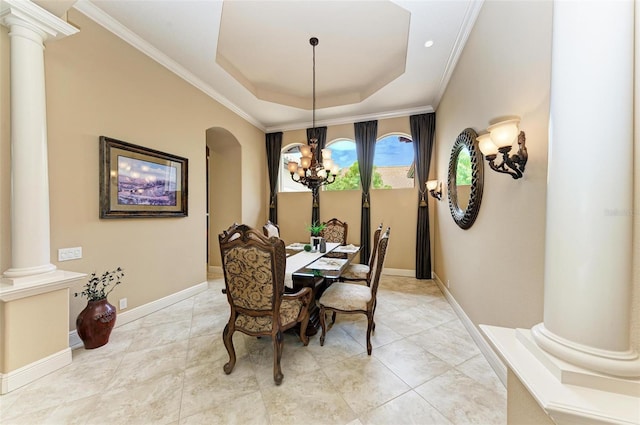 dining space featuring an inviting chandelier, ornate columns, tile patterned floors, a raised ceiling, and ornamental molding