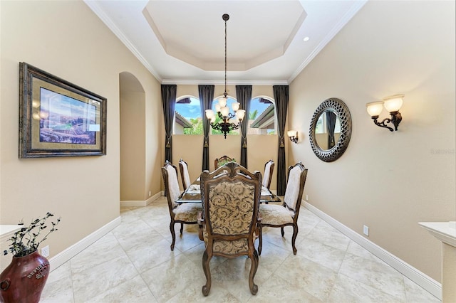 tiled dining room featuring a notable chandelier, crown molding, and a raised ceiling