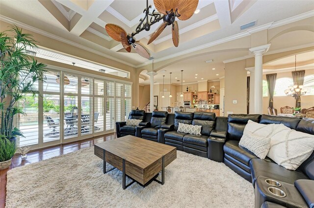 living room featuring beamed ceiling, ornate columns, coffered ceiling, and crown molding