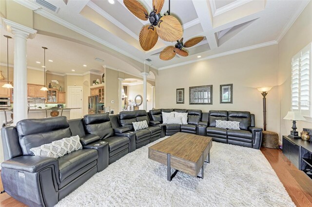 living room with ornamental molding, decorative columns, coffered ceiling, and ceiling fan