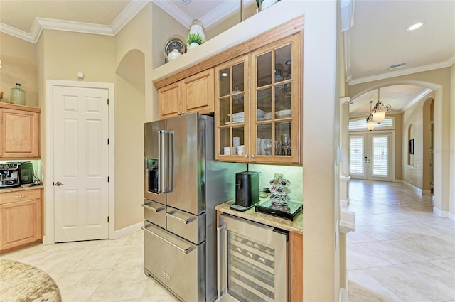 kitchen with high quality fridge, beverage cooler, crown molding, and light tile patterned floors