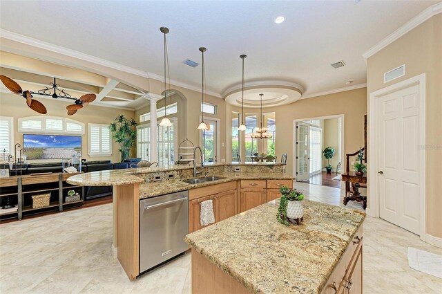 kitchen with stainless steel dishwasher, sink, light stone counters, and a center island with sink