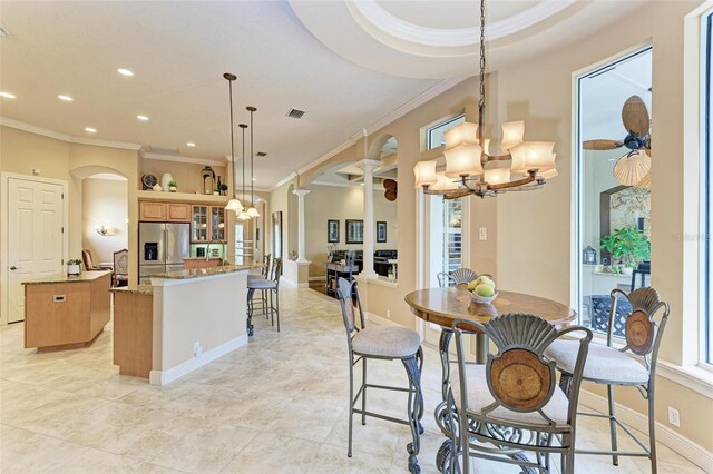 tiled dining area with ceiling fan with notable chandelier and ornamental molding