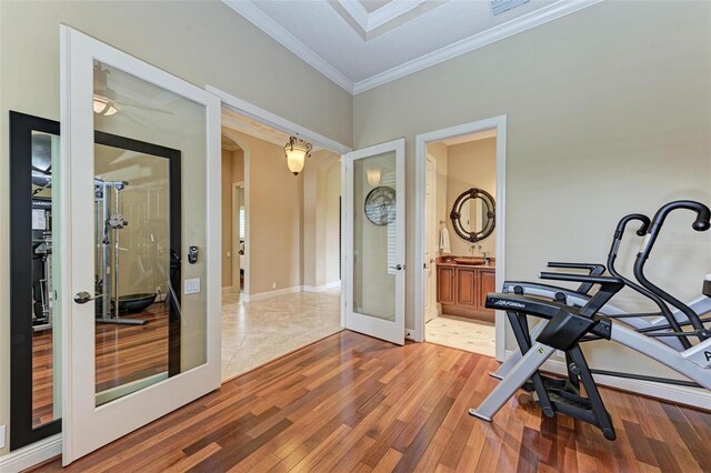 workout area featuring tile patterned floors, french doors, and ornamental molding