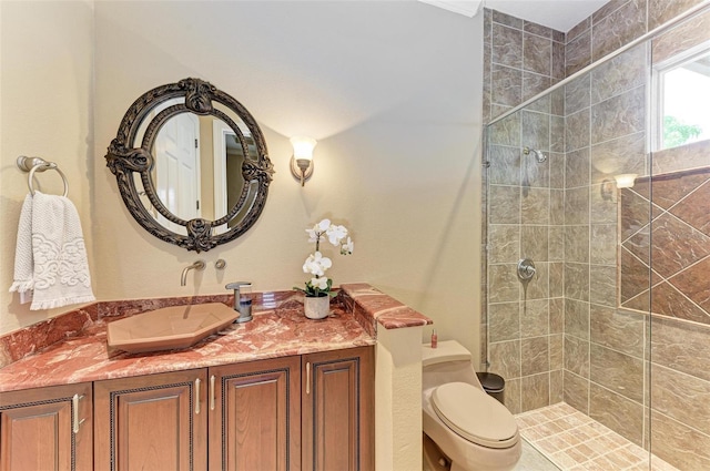 bathroom featuring tiled shower, toilet, and vanity