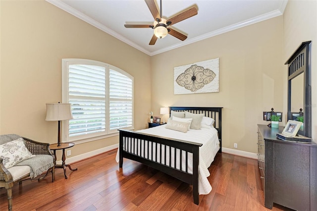 bedroom featuring ornamental molding, dark hardwood / wood-style flooring, and ceiling fan