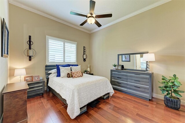 bedroom featuring ceiling fan, dark hardwood / wood-style flooring, and ornamental molding