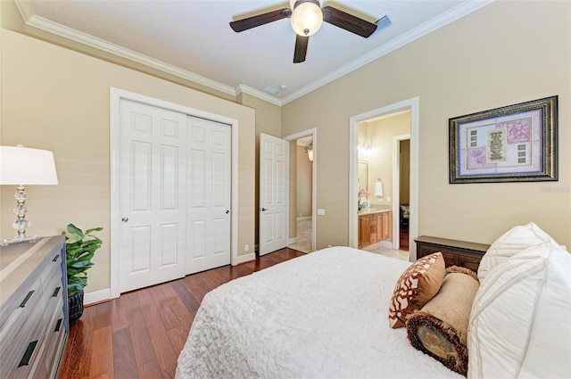 bedroom featuring ensuite bathroom, a closet, dark wood-type flooring, ceiling fan, and ornamental molding