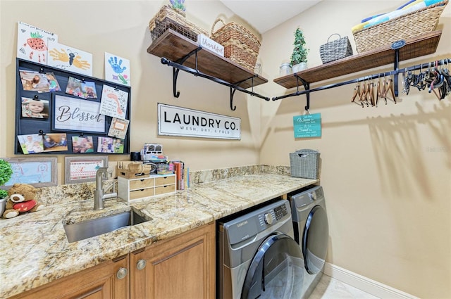 laundry room featuring sink, cabinets, and washing machine and dryer