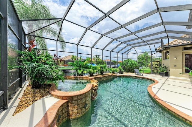 view of swimming pool featuring a patio, an in ground hot tub, and a lanai