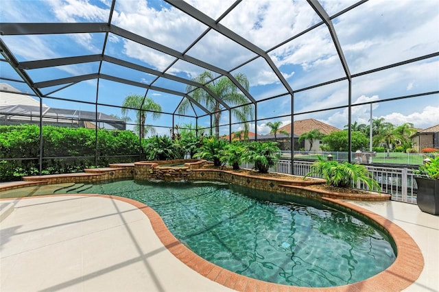 view of pool featuring an in ground hot tub, a patio, and a lanai