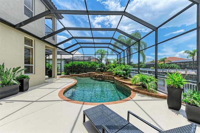 view of pool featuring a patio area and glass enclosure