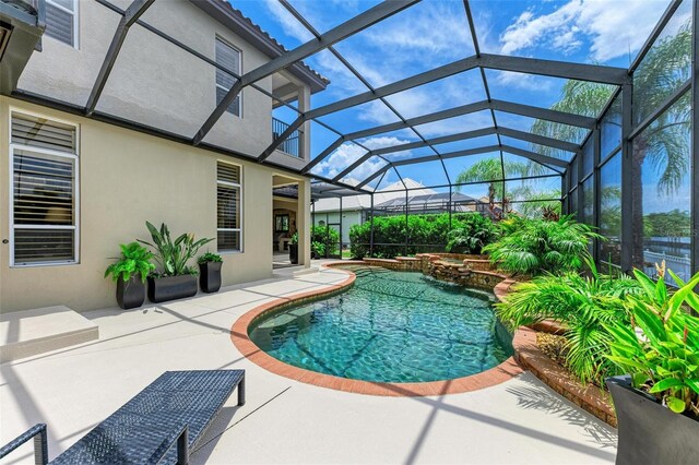 view of swimming pool with glass enclosure and a patio area