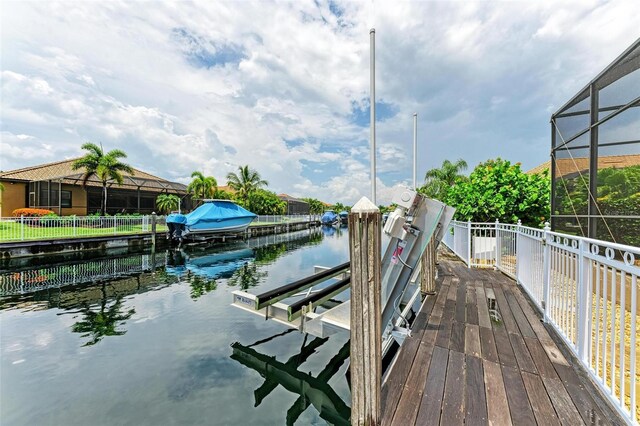 view of dock featuring a water view and glass enclosure