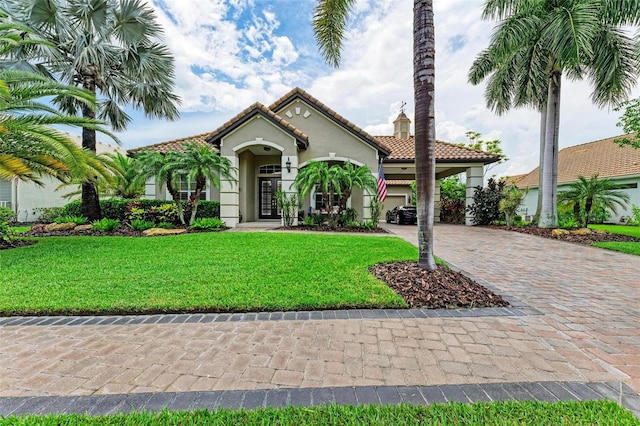 mediterranean / spanish house featuring a front yard