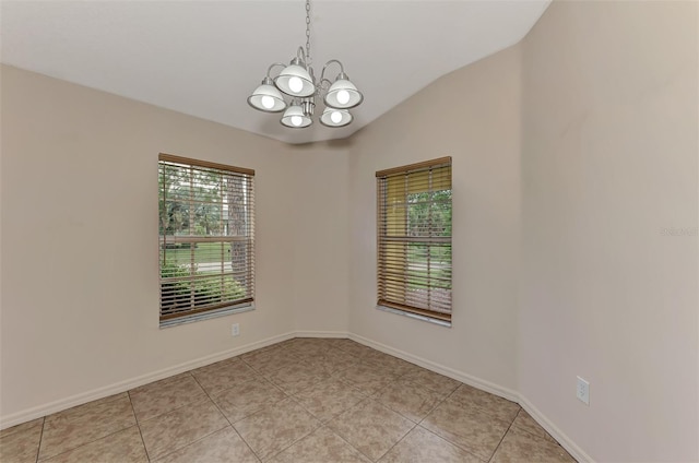 unfurnished room with light tile patterned floors, vaulted ceiling, and a notable chandelier