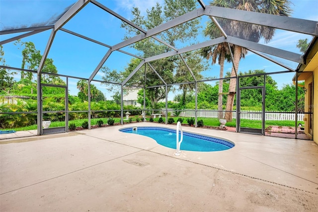 view of swimming pool featuring a lanai and a patio area