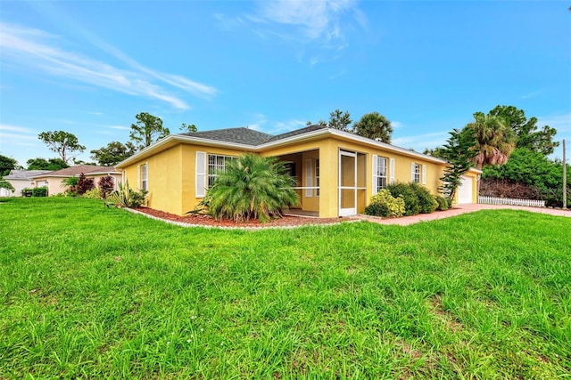 single story home with a garage and a front yard