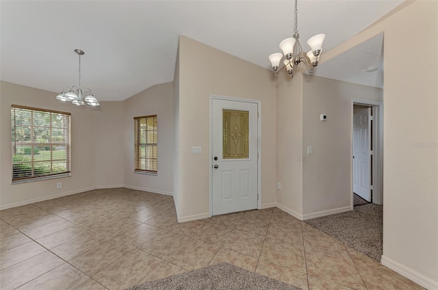 interior space with light tile patterned flooring, a chandelier, and vaulted ceiling