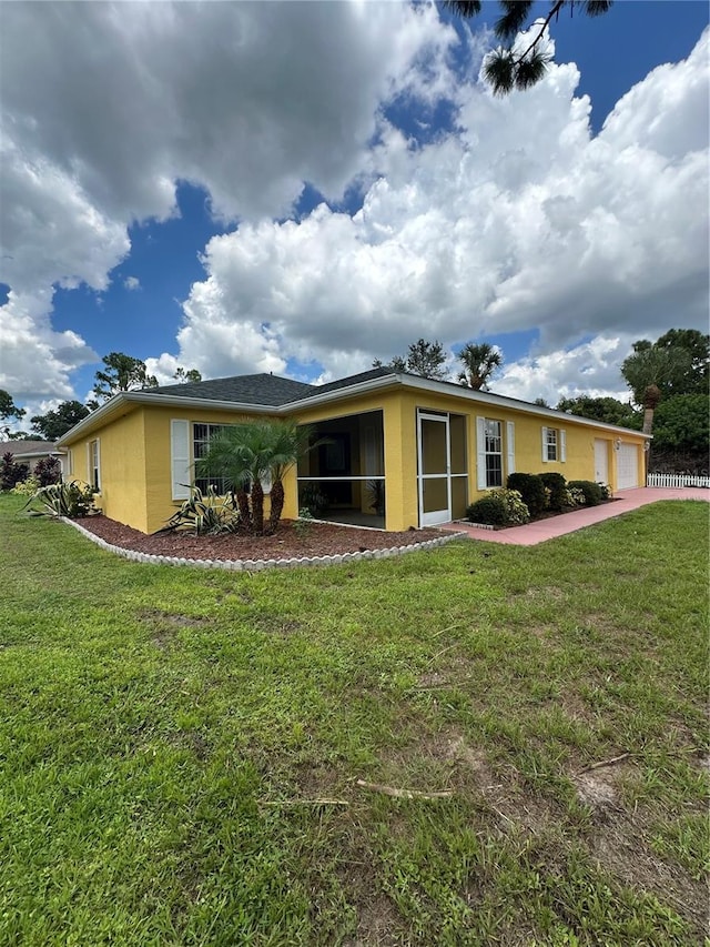 view of front of property with a front yard and a sunroom