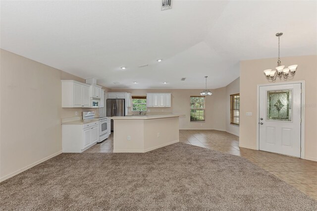 kitchen with white appliances, a kitchen island, decorative light fixtures, white cabinetry, and light tile patterned floors