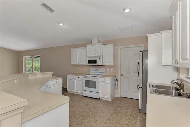 kitchen with light tile patterned floors, sink, white appliances, and white cabinetry