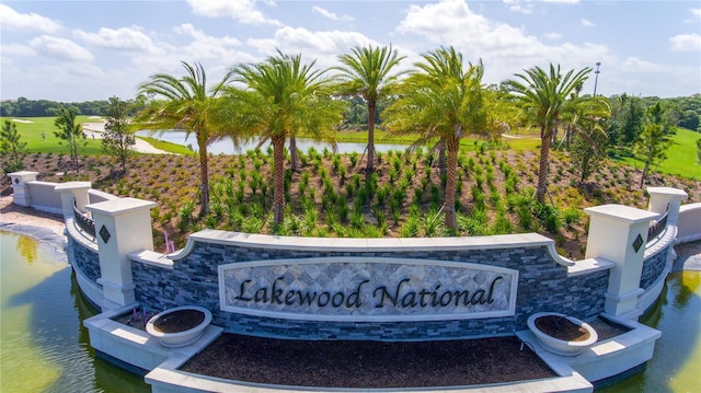 community / neighborhood sign with a water view