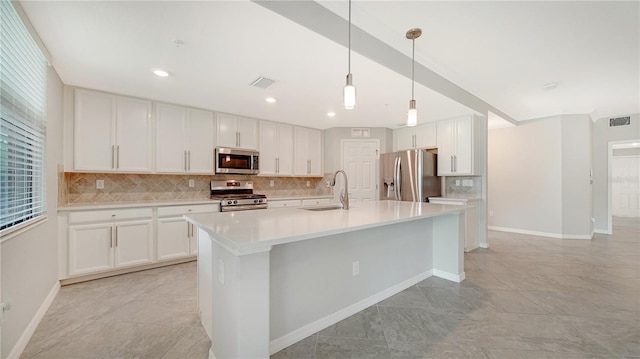 kitchen with decorative light fixtures, appliances with stainless steel finishes, sink, and white cabinetry