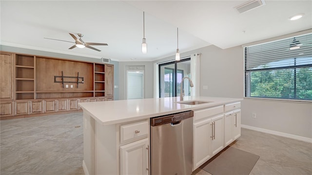 kitchen featuring decorative light fixtures, white cabinetry, sink, stainless steel dishwasher, and a center island with sink