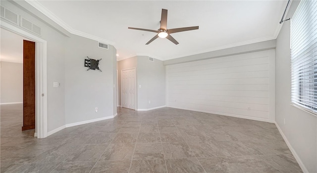 spare room with ceiling fan and ornamental molding