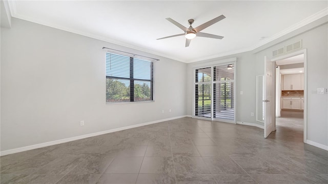 empty room with ceiling fan, tile patterned flooring, and crown molding