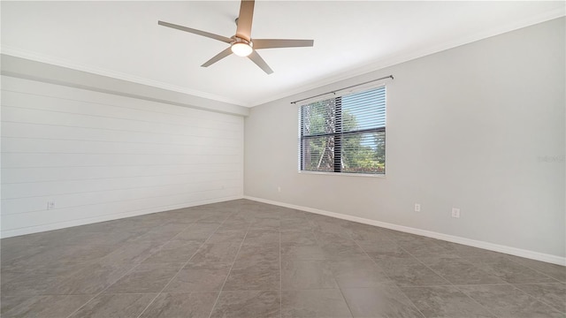 spare room with ceiling fan and crown molding