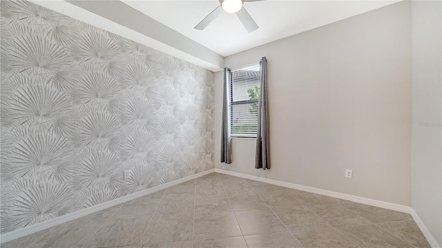 empty room featuring ceiling fan and light tile patterned floors