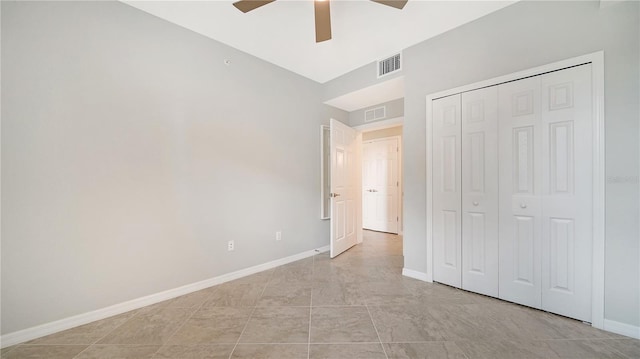 unfurnished bedroom featuring ceiling fan, light tile patterned flooring, and a closet